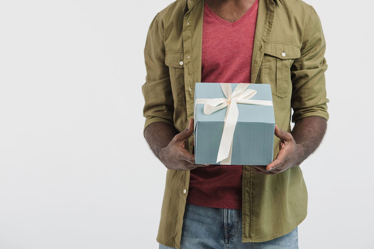 Gift Ideas Man holding a gift box from San Antonio custom merchandise.
